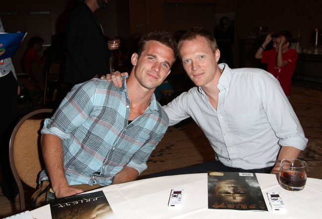 Cam Gigandet, green plaid shirt, tan pants, Paul Bettany, white shirt, black pants